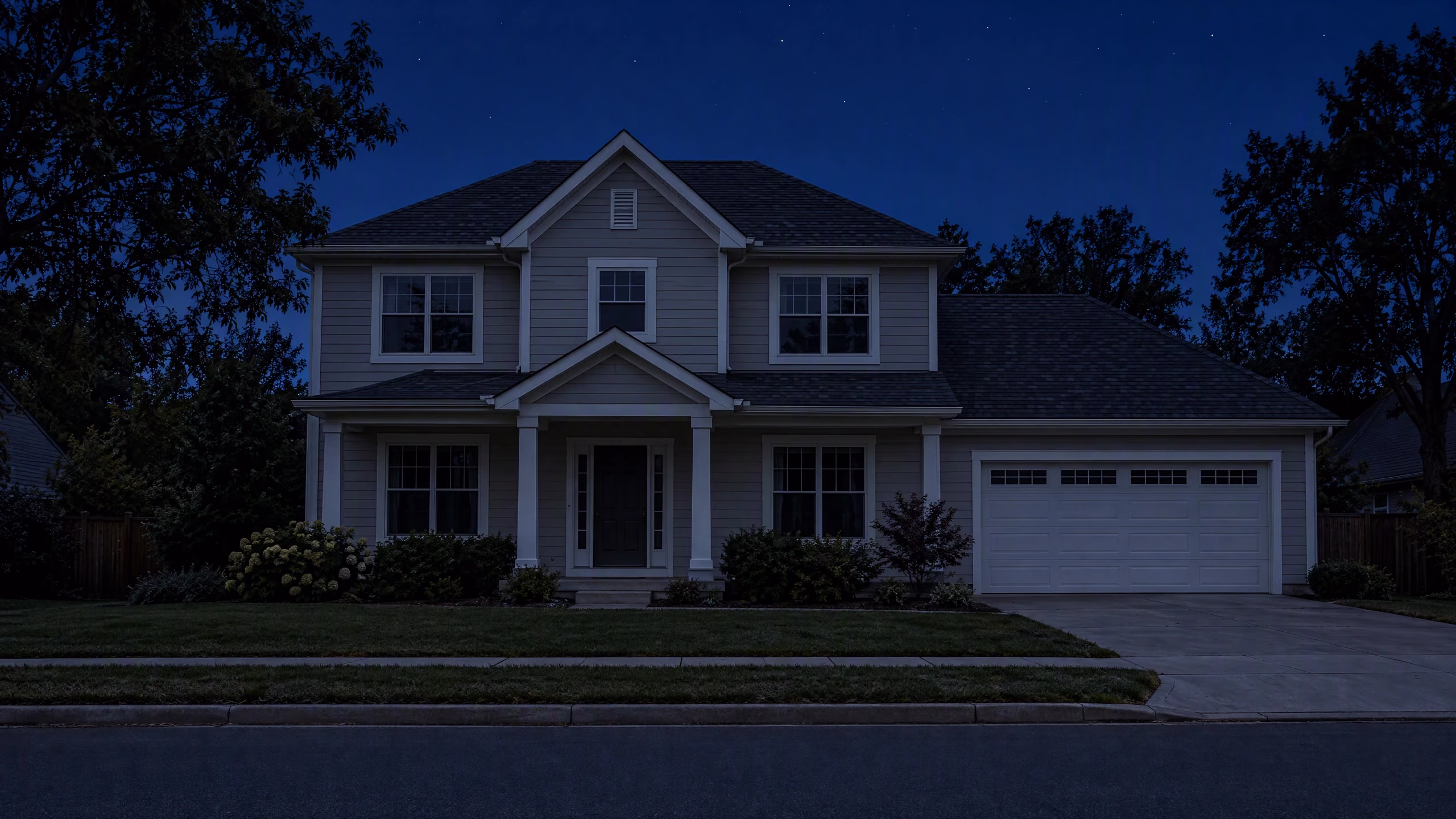 A two-storey house at dusk with every light off